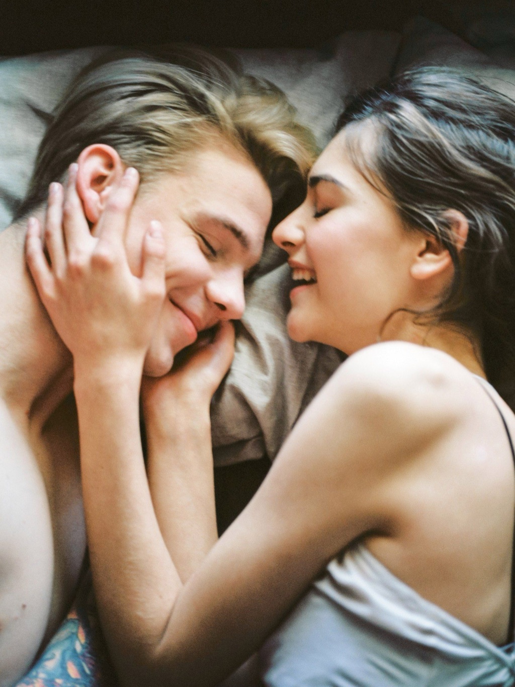 A smiling couple holding each other close