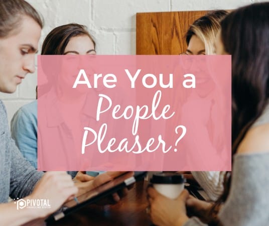 A graphic that reads "Are You a People Pleaser?" over a stock photo of group of people chatting over a table on a pink background.