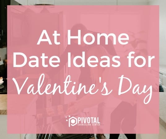 Graphic that reads "At Home Date Ideas for Valentine's Day" on a pink square over a stock photo of a couple putting a tray in the oven.